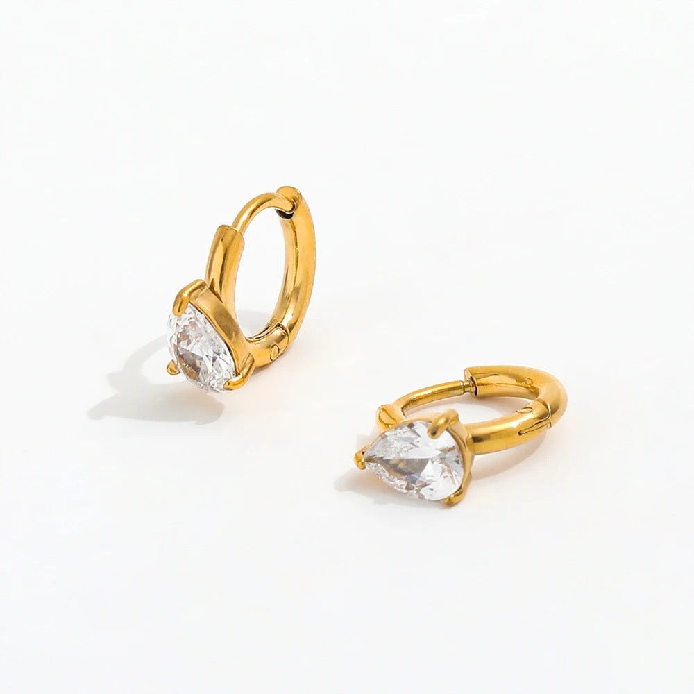 Elegant gold tone earrings featuring clear crystal, inspired by the delicate Lily flower. Waterproof, tarnish free, crafted from stainless steel & 18K gold plating.